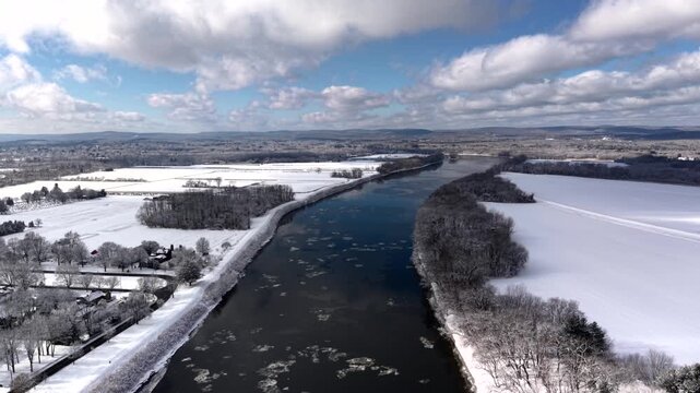 Aerial panorama of frozen Connecticut River in snow-covered and charming environment, Hadley, Western Massachusetts, USA