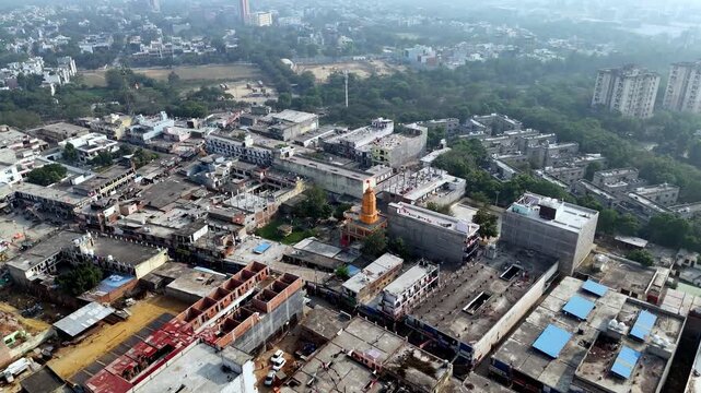 Aerial of a mandir surrounded by crowded rooftops and busy lanes in Greater Noida, reflecting the city&rsquo;s grassroots spirituality within a fast-expanding urban landscape.