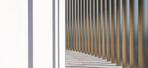 Abstract modern colonnade with repeating vertical columns and soft sunlight