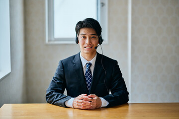 Customer Support Operator Smiling at Camera in Office