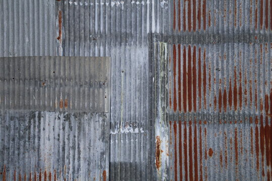 Artistic of old and rusty zinc sheet wall. Vintage style metal sheet roof texture. Pattern of old metal sheet. Rusting metal or siding. Corrosion of galvanized. Background and texture in retro concept