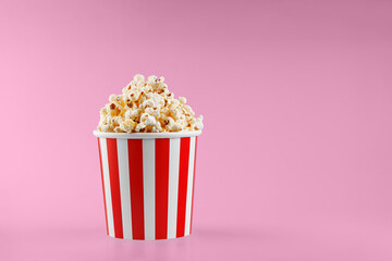 Classic red striped popcorn cardboard cup on Red background