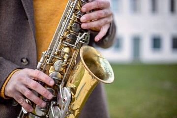 Obraz premium Close Up of Musician Playing Saxophone Outdoors