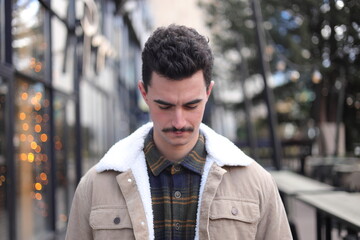 Fototapeta premium Man looking down thoughtful in city