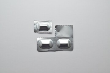 Capsules in foil blister packs on a gray background