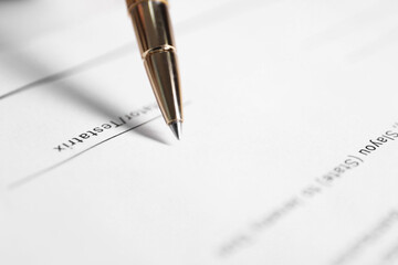 Signing Last Will and Testament at table, closeup