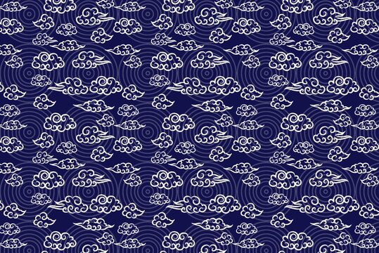 Elegant seamless pattern featuring traditional East Asian-inspired white auspicious clouds and intricate wave motifs on a deep indigo background, perfect for cultural designs and serene backdrops