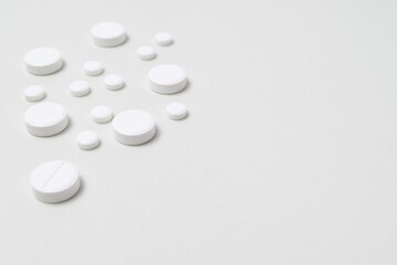 White pills on a white background