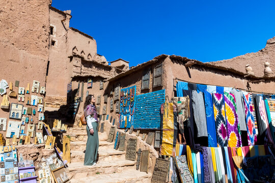 A woman looks at souvenirs outside a shop in a kasbah. Kasbah ait ben haddou,Marrakech,Morocco