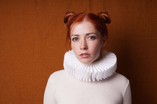 young woman with red space buns or odango hair style and white Elizabethan ruff collar