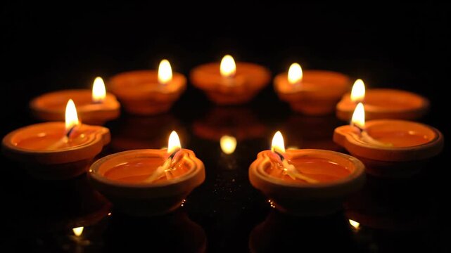 Traditional Diya Clay Lamps Glowing in Darkness for Festival