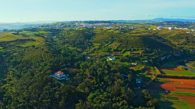 Top view of a European town with beautiful green landscape during sunset. Drone view of a beautiful small European city with a beautiful hilly landscape while sunset.  Cinematic   footage. Portugal.