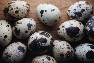 Fototapeta premium Raw quail eggs on wooden table