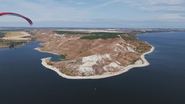 Paraplane flying over podvalskie chalk hills and don river