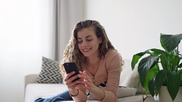 Relaxed and happy woman scroll social media and reading on her phone 