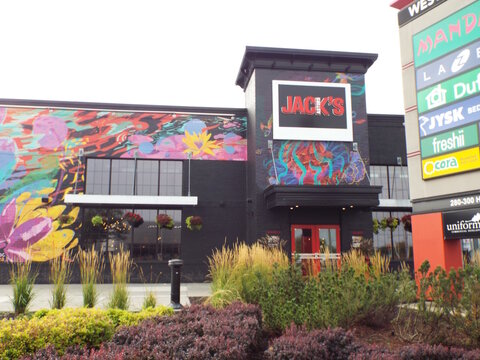 Ottawa, ON, Canada-July 13,2025: A close-up view of the "Jack Astor's" restaurant storefront and mural on at 310 W Hunt Club Rd.
