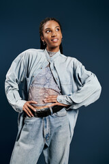 Young woman radiates confidence in stylish denim attire against a chic backdrop