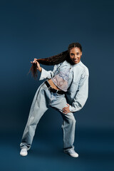 Fashionable young woman expressing joy in a stylish denim outfit