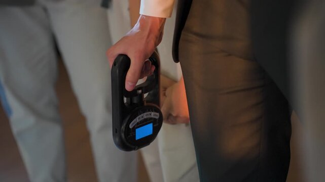 A man squeezes a wrist strength expander
