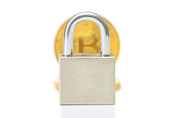 Naklejka premium Blurred bitcoin gold coin under lock isolated on white background. Front focus