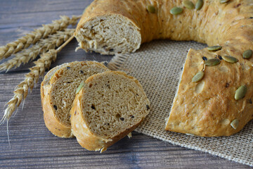 a close up of Rustic Whole Grain Bread with Pumpkin Seeds on burlap texture
