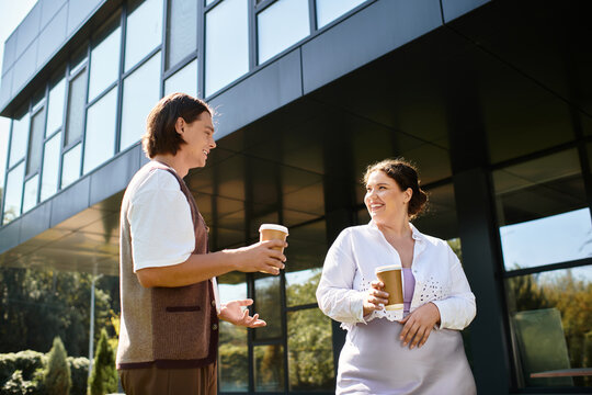 Colleagues sharing smiles and coffee during a sunny workday in a modern office