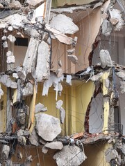 Exposed Rebar and Concrete Hanging from Partially Demolished Building. Dangerous Demolition Scene with Swinging Rebar and Rubble. Collapsed Structure with Hanging Metal and Concrete Fragments.