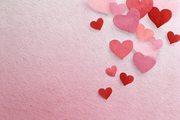 Hearts scattered on a pink background for celebration of love and affection on special occasions