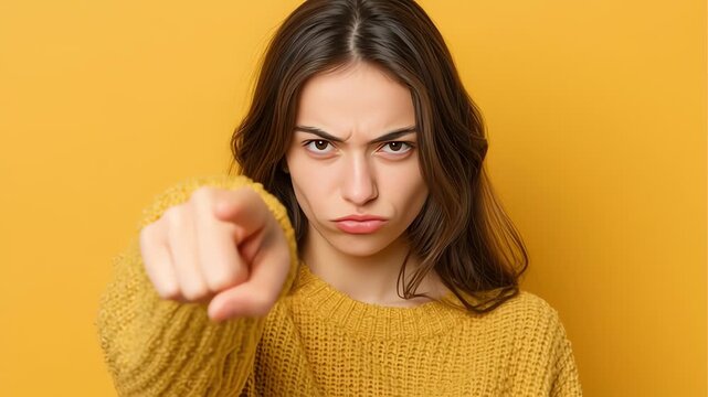 Angry young woman pointing finger.