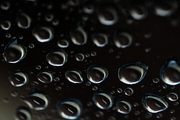 Water droplets on dark glass abstract macro texture, Horizontal