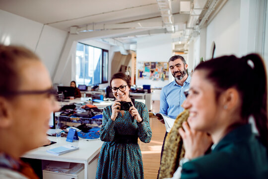Creative team taking photos in modern office