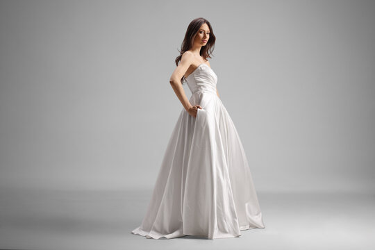 Woman wearing simple elegant strapless white satin ball gown