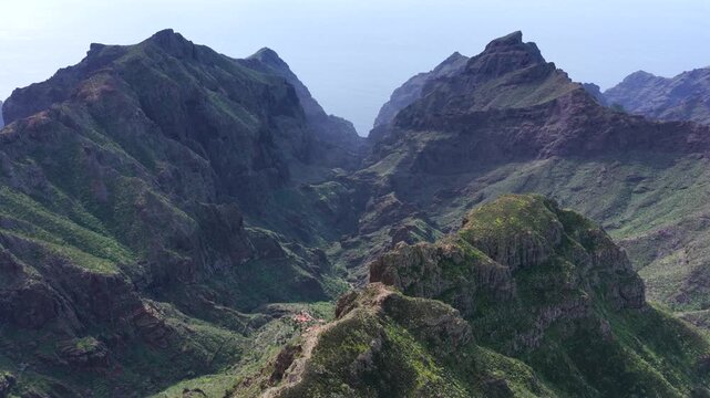 Cinematic aerial of the winding mountain road switchbacks leading to Masca village in Teno Rural Park Tenerife