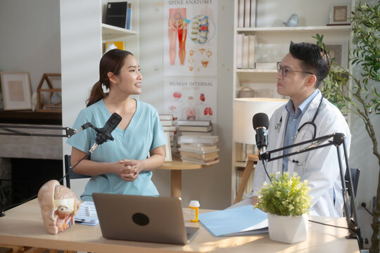 Asian male and female doctors hosting medical podcast together.