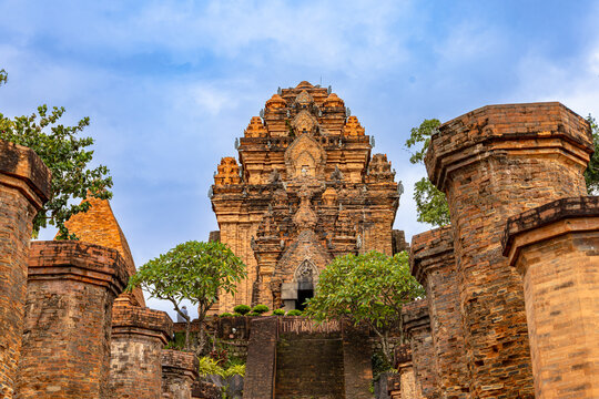 Cham temple complex with large pillars and shrine of mother goddess Po Nagar in the center with lintel above the doorway depicng the Hindu goddess Durga, located in Nha Trang, Vietnam
