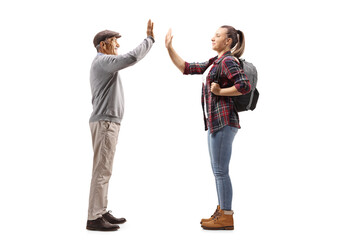 Fototapeta premium Mature man and a young female student giving high-five