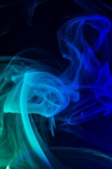Abstract blue smoke waves flowing on a black background