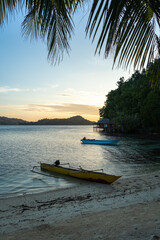 Boat at sunset on Bolilanga Island, Togian archipelago, Sulawesi, Indonesia