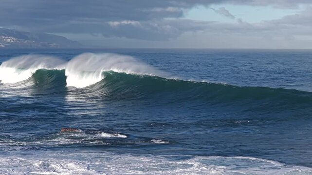 Cinematic aerial of massive Atlantic waves crashing on Gran Canaria coast with dangerous swell and red flag sea conditions