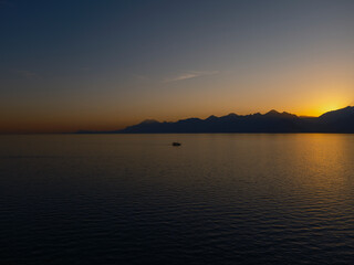 Obraz premium Scenic sunset view with mountains and serene ocean