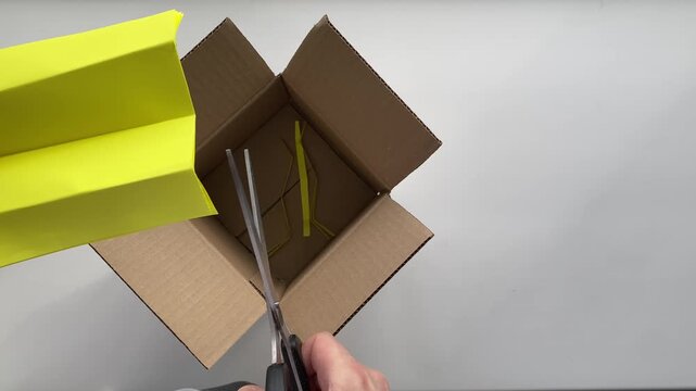 Scissors. Cut paper. Package. Fragile gift. Slow motion video. High quality 4k footage