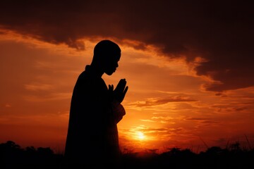 Spirituality in nature praying silhouette at sunset