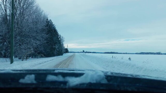 Dash camera footage of a drive down a snowy country road
