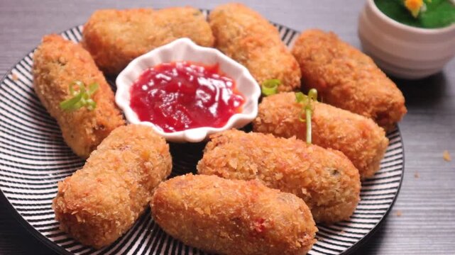 fried vegetables nuggets dipping in sauce and eating 