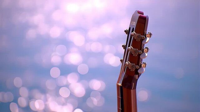 Guitar headstock with bokeh background.