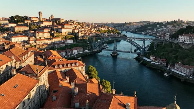Aerial view of the Dom Lu&Atilde;&shy;s I Bridge over the Douro River in Porto, Portugal with old city buildings and rooftops