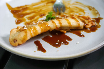 Delicious Caramel French Toast Topped with Fresh Strawberry and Mint Leaf Garnish on a White Plate © Jaenal Jalalludin