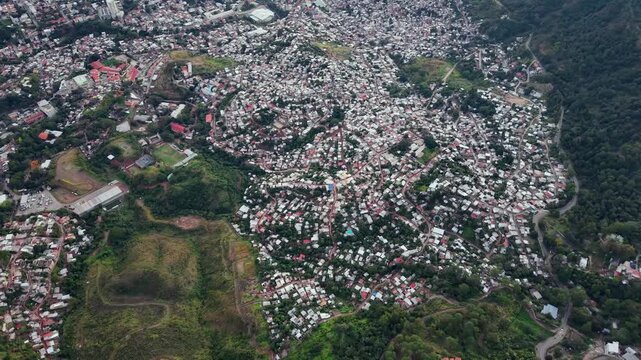Beautiful aerial night view of Tegucigalpa, capital of Honduras and Comayaguela, surrounded by mountains and the city glowing across the urban valley