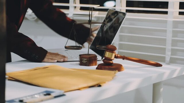 justice and law concept.Male judge in a courtroom on wooden table and Counselor or Male lawyer working in office. Legal law, advice and justice concept.