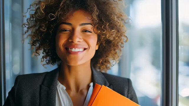 Smiling Businesswoman Holding Orange Folder.